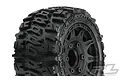 A close-up of a Pro-Line 2.8 inch Trencher tyre mounted on a black Raid rim, showing the aggressive tread pattern and wheel detail.