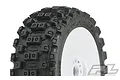 A close-up of a Pro-Line Badlands MX tyre mounted on a white dish rim, showing the aggressive block tread pattern.