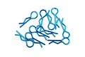 A collection of ten laser blue metal body clips for RC cars scattered on a white background.