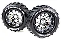 Two Louise 3.3 inch MT-Cyclone monster truck tyres mounted on black chrome beadlock-style rims against a white background.