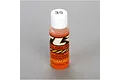 A bottle of TLR 35w silicone shock oil with an orange liquid, white cap, and branded label on a grey surface.