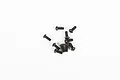 A small pile of ten black metal button head screws for RC models against a plain white background.