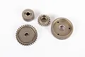 A set of four metal transmission gears for an RC vehicle, arranged on a plain white background.