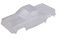 An unpainted, clear polycarbonate RC truck body shell for a 1/10 scale crawler, viewed from a high angle.