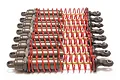 A set of eight Traxxas Big-Bore aluminium shock absorbers with red springs and gunmetal grey bodies, arranged in a row against a white background.