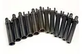 A collection of twelve black plastic splined half shaft components for Traxxas RC vehicles arranged in a semi-circle on a white background.