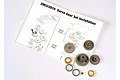 Traxxas servo gear set components including plastic gears, metal bushings, and an installation instruction sheet.