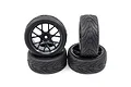 A set of four Yeah Racing 1.9 inch on-road RC car wheels with black multi-spoke rims and treaded rubber tyres arranged in a stack.