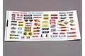 A white decal sheet featuring various automotive and racing sponsor logos including Traxxas, Holley, MSD, and K&N, designed for RC car customization.