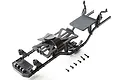 Axial SCX24 main chassis set featuring black plastic frame rails, battery tray, and mounting hardware on a white background.