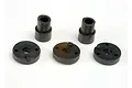 A set of black plastic shock pistons and bushings for Traxxas RC vehicles, arranged on a white background.