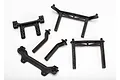 A set of black plastic Traxxas RC body mounts and posts arranged on a white background.
