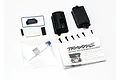 Traxxas sealed receiver box set including black plastic housing, screws, O-ring, foam pads, grease, and instruction manual on a white background.