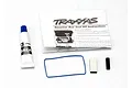 Traxxas receiver box seal kit including a tube of grease, a blue rubber O-ring, two foam pads, and an instruction manual.