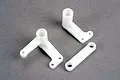 Traxxas steering bellcranks and drag link set, showing two white plastic bellcrank arms and one straight drag link on a grey background.