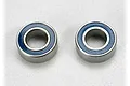 Two Traxxas 5x10x4mm rubber shielded ball bearings shown side by side on a light grey surface.