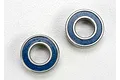 Two Traxxas 6x12x4mm rubber shielded ball bearings with blue seals on a white background.