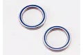 Two Traxxas rubber-shielded ball bearings with blue seals on a white background.