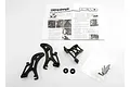Traxxas Revo wing mount set including black plastic mounts, hardware in a plastic bag, and an instruction sheet on a white background.