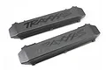 Two black Traxxas battery door covers for RC vehicles, shown from an angled top-down perspective on a white background.