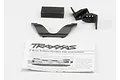 Traxxas E-Revo battery retainer clip set including plastic clips, a foam block, and an instruction sheet on a white background.