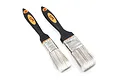 Two Yeah Racing cleaning brushes with black and orange handles, one 25mm and one 35mm, featuring white bristles and metal ferrules.