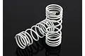 Two white progressive rate RC shock springs with black identification markings, positioned on a dark reflective surface.