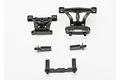 A set of black plastic Traxxas front and rear body mount components for an RC car, arranged on a white background.