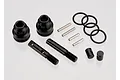 A Traxxas drive shaft rebuild kit containing two black drive cups, two threaded shafts, four metal pins, three O-rings, and two small black bushings.