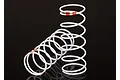 Two white Traxxas RC shock springs with orange identification markings on a black background.