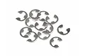 A pile of twelve small silver-coloured stainless steel E-clips for RC vehicles on a white background.