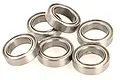 A cluster of six silver metal shielded ball bearings arranged on a white background.