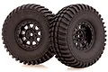 Two black RC off-road wheels with aggressive tread patterns and black 9-spoke rims, isolated on a white background.