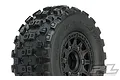 A close-up studio shot of a Pro-Line Badlands MX SC tyre mounted on a black Raid wheel for RC short course trucks.