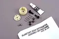 Traxxas 2388 planetary differential gear set including plastic housing, metal gears, pins, screws, grease tube, and instruction manual.