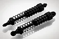 Two black RC shock absorbers for the BlackZon 1/12 Warrior, featuring coil springs and plastic bodies, isolated on a white background.