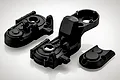 Black plastic RC gearbox case components for BlackZon 1/12 Warrior, including main housing and cover pieces.