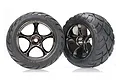 Two Traxxas 2.2 inch Anaconda rear buggy tyres pre-glued onto black chrome Tracer wheels, shown against a white background.