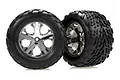 Two Traxxas 2.8 inch Talon tires mounted on chrome All-Star wheels against a white background.