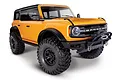A studio shot of a bright orange Traxxas TRX-4 2021 Ford Bronco RC rock crawler on a white background.
