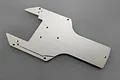 A silver aluminium rear skid plate for an RC vehicle, featuring a flat, machined design with multiple mounting holes.