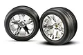 Two Traxxas 2.8-inch ribbed tires pre-glued onto chrome-finished All-Star five-spoke wheels, shown against a white background.
