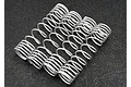A set of four white progressive rate shock springs for Traxxas RC vehicles arranged on a dark textured surface.