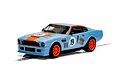A 1/32 scale Scalextric Aston Martin V8 slot car in Gulf livery, featuring light blue paint with orange accents and the number 19 on the hood and doors.