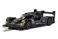 A 1/32 scale Scalextric Batman slot car featuring a dark, weathered grey and black aerodynamic racing design on a white background.