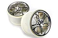 Two Traxxas 3.8 inch split-spoke RC monster truck rims with a satin chrome finish and white plastic barrels.