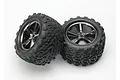 Two Traxxas 3.8 inch Talon monster truck tyres pre-glued onto black chrome Gemini rims against a white background.