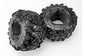 Two black Traxxas 3.8 inch Canyon AT RC monster truck tires with foam inserts visible inside, set against a plain white background.