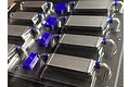 A plastic sprue containing several unpainted 1/10 scale RC intercooler parts and small blue components.