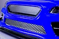 Close-up of a blue RC car front bumper featuring silver 3D cross mesh decal applied to the grille areas.